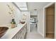 Bright bathroom featuring a long vanity with double vessel sinks and modern finishes at 3034 Gull Pl, Clearwater, FL 33762