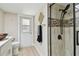Bright bathroom with glass shower door, shower tile accent, and toilet at 3034 Gull Pl, Clearwater, FL 33762