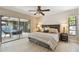 This main bedroom features an ensuite bath, wood-look floors, and pool view at 3034 Gull Pl, Clearwater, FL 33762