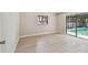 Bedroom featuring light wood floors and a large sliding glass door to the pool area at 3034 Gull Pl, Clearwater, FL 33762