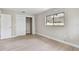 A bright bedroom with light wood floors, a double closet and a window to the backyard at 3034 Gull Pl, Clearwater, FL 33762