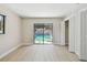 Bedroom with light wood floors, closet and sliders with a view of the screened in pool at 3034 Gull Pl, Clearwater, FL 33762