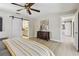 Light-filled bedroom features a sliding barn door to the ensuite bathroom and wood-look floors at 3034 Gull Pl, Clearwater, FL 33762