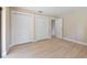 Bedroom features neutral walls, light wood floors, and closet space at 3034 Gull Pl, Clearwater, FL 33762