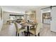 Bright dining area featuring a metal table and decor, open to a living area and kitchen beyond at 3034 Gull Pl, Clearwater, FL 33762