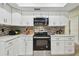Modern kitchen with stainless steel appliances, mosaic backsplash, and ample counter space at 3034 Gull Pl, Clearwater, FL 33762