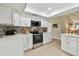 Well-equipped kitchen with stainless steel oven, microwave, and modern white cabinetry at 3034 Gull Pl, Clearwater, FL 33762