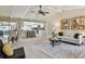 Inviting living room with modern decor, including stylish artwork and a cozy sofa, next to a breakfast bar overlooking the kitchen at 3034 Gull Pl, Clearwater, FL 33762