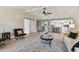 Bright open-concept living room features a vaulted ceiling, sliding barn door, and seamless flow into the modern kitchen at 3034 Gull Pl, Clearwater, FL 33762