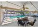 Screened-in pool area with a covered patio, ceiling fans, and comfortable seating at 3034 Gull Pl, Clearwater, FL 33762