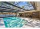 Inviting pool area with screened enclosure, offering a perfect spot for relaxation and recreation at 3034 Gull Pl, Clearwater, FL 33762