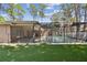 View of the screened-in pool with an outdoor seating area and artificial turf at 3034 Gull Pl, Clearwater, FL 33762