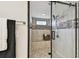 Modern shower stall with a built-in bench and seamless glass doors at 3034 Gull Pl, Clearwater, FL 33762