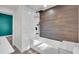 Stylish bathroom showcasing tiled shower with black fixtures and wooden accent wall at 3101 N 15Th St, Tampa, FL 33605