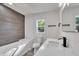 Bright bathroom features wood accent wall, subway tile, and modern fixtures at 3101 N 15Th St, Tampa, FL 33605