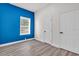 Bedroom with sleek floors, blue accent wall, window, and dual closets at 3101 N 15Th St, Tampa, FL 33605