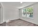 Bright, airy bedroom with two windows, laminate flooring, and fresh paint at 3101 N 15Th St, Tampa, FL 33605