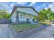 Charming bungalow featuring a welcoming front porch, fresh landscaping, and stylish exterior paint at 3101 N 15Th St, Tampa, FL 33605