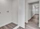 Hallway with laminate flooring, leading to laundry area and front entry at 3101 N 15Th St, Tampa, FL 33605