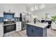 Bright open kitchen with island, stainless steel refrigerator, and views into the living space at 3101 N 15Th St, Tampa, FL 33605
