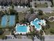 Aerial view of community pool, tennis courts, clubhouse and manicured landscaping at 34329 Evergreen Hill Ct, Wesley Chapel, FL 33545