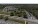 Aerial view of local roads and a large building complex within a wooded area at 34329 Evergreen Hill Ct, Wesley Chapel, FL 33545
