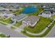 Aerial view of a house and community, showcasing a pond and well-maintained landscaping at 34329 Evergreen Hill Ct, Wesley Chapel, FL 33545