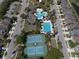 An aerial view of the community pool area, featuring tennis courts and lush landscaping at 34329 Evergreen Hill Ct, Wesley Chapel, FL 33545