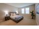 Comfortable bedroom with neutral walls, plush carpeting, a queen-size bed, bedside tables, and stylish lamps at 34329 Evergreen Hill Ct, Wesley Chapel, FL 33545