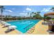 Inviting community pool with marked lanes, palm trees, and lounge area at 34329 Evergreen Hill Ct, Wesley Chapel, FL 33545