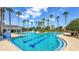 Resort-style pool with sun loungers and swaying palm trees at 34329 Evergreen Hill Ct, Wesley Chapel, FL 33545