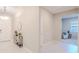Inviting foyer with sleek console table, round mirror, modern light fixture, and stylish accents at 34329 Evergreen Hill Ct, Wesley Chapel, FL 33545