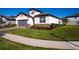 Charming single-story home with a manicured lawn, stone accents, and a two-car garage at 34329 Evergreen Hill Ct, Wesley Chapel, FL 33545
