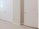 Hallway showing the carpeted floor, white doors, and neutral wall coloring at 34329 Evergreen Hill Ct, Wesley Chapel, FL 33545