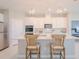Modern kitchen featuring white cabinets, stainless steel appliances, and an island with bar seating at 34329 Evergreen Hill Ct, Wesley Chapel, FL 33545