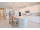 Bright kitchen features stainless steel appliances, an island with barstool seating, and white cabinetry at 34329 Evergreen Hill Ct, Wesley Chapel, FL 33545
