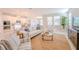 Inviting living room featuring neutral furnishings, large windows, and an open floor plan at 34329 Evergreen Hill Ct, Wesley Chapel, FL 33545