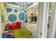 Cheerful playroom with playful decor, built-in shelving, and a green carpet; ideal for children at 34329 Evergreen Hill Ct, Wesley Chapel, FL 33545