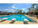 Large community pool with lap lanes, palm trees, lounge seating, and well-maintained landscaping at 34329 Evergreen Hill Ct, Wesley Chapel, FL 33545