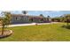 Expansive grassy backyard featuring a private pool, ideal for entertaining and relaxation at 4 Oakland Hills Ct, Rotonda West, FL 33947
