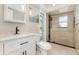 Updated bathroom featuring tiled shower with glass door, and a modern vanity at 4 Oakland Hills Ct, Rotonda West, FL 33947