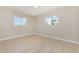 Bedroom featuring tile flooring, neutral colors, and two windows at 4 Oakland Hills Ct, Rotonda West, FL 33947