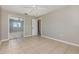 Neutral bedroom with ceiling fan, light tile floor and mirrored closet at 4 Oakland Hills Ct, Rotonda West, FL 33947