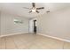 A bright and spacious bedroom featuring tile flooring and a ceiling fan at 4 Oakland Hills Ct, Rotonda West, FL 33947