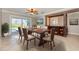 Dining area featuring sliding doors to the pool, neutral colors, and modern lighting at 4 Oakland Hills Ct, Rotonda West, FL 33947