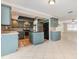 Spacious kitchen featuring tile floors, blue cabinets, stainless steel appliances, and a center island at 4 Oakland Hills Ct, Rotonda West, FL 33947