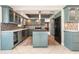 Updated kitchen with blue cabinets, tile backsplash, and stainless steel appliances at 4 Oakland Hills Ct, Rotonda West, FL 33947