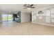 Open concept living room featuring tile floors and views of the kitchen and outdoor pool at 4 Oakland Hills Ct, Rotonda West, FL 33947