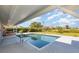 A lovely pool with a clear view is nestled in the green backyard at 4 Oakland Hills Ct, Rotonda West, FL 33947