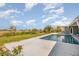 Beautiful pool area with lush lawn, perfect for outdoor enjoyment and relaxation at 4 Oakland Hills Ct, Rotonda West, FL 33947